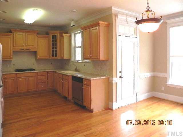 213 Waterville Street Raleigh, NC 27603 - Photo 9 of 24 a kitchen with a sink cabinets and window