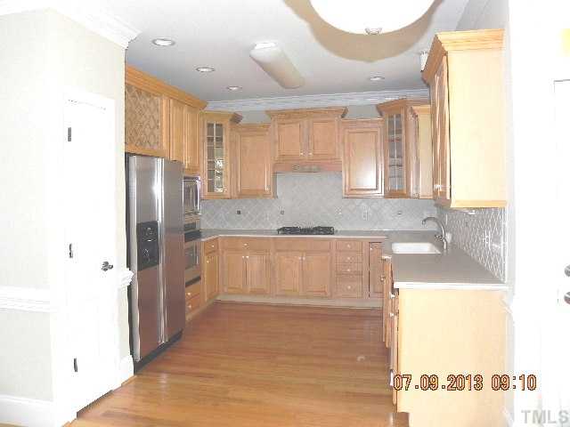 213 Waterville Street Raleigh, NC 27603 - Photo 10 of 24 a kitchen with stainless steel appliances granite countertop a refrigerator and a sink