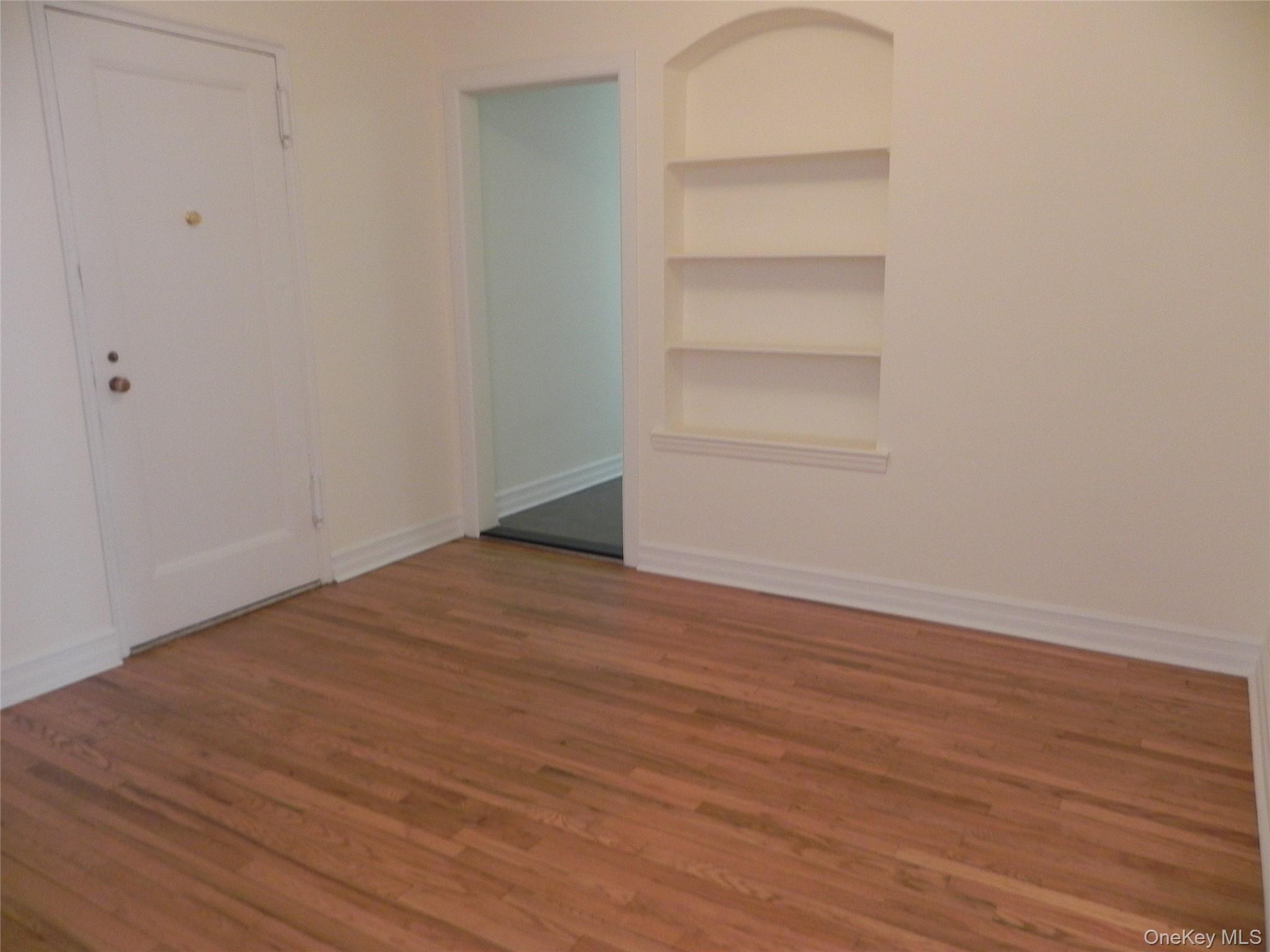 160 South Middle Neck Road, Unit 1N Great Neck, NY 11021 - Photo 4 of 15 Entry alt view with built in shelves and hardwood flooring