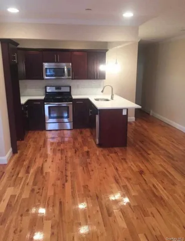 a kitchen with stainless steel appliances wooden cabinets and granite counter tops