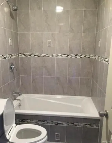 a bathroom with a tub a sink and toilet