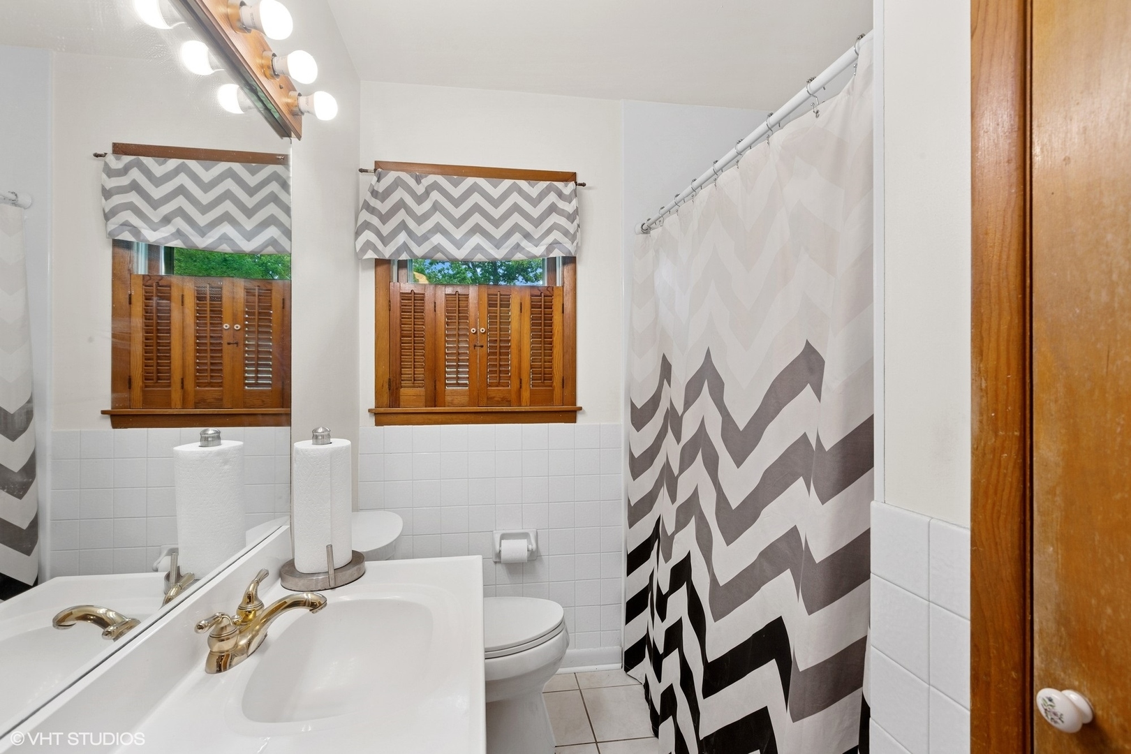 43W888 Hughes Road Elburn, IL 60119 - Photo 15 of 25 a bathroom with a sink a toilet and shower curtain