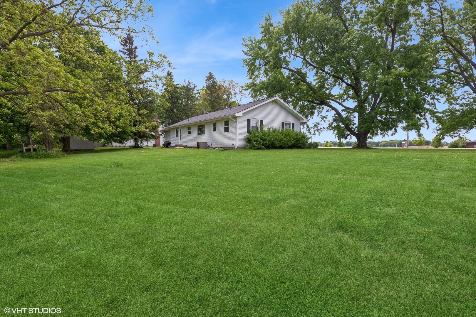 43W888 Hughes Road Elburn, IL 60119 - Photo 17 of 25 a front view of a house with a yard and trees