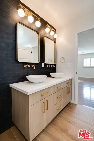 a bathroom with a double vanity sink and a mirror