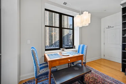 a blue chair sitting in a room next to a window