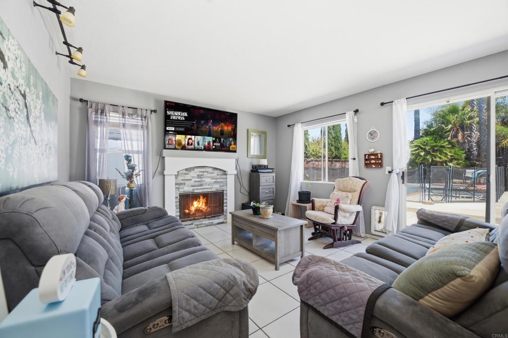 2077 Westwood Road Vista, CA 92083 - Photo 11 of 37 a living room with furniture fireplace and a large window
