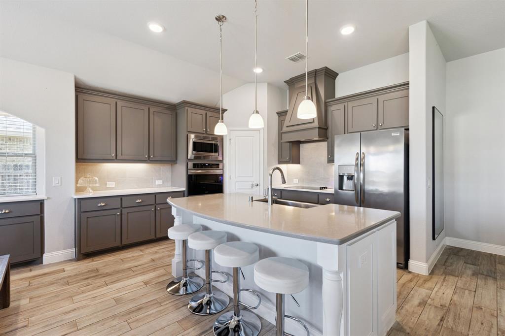 1620 Irene Drive Crowley, TX 76036 - Photo 7 of 36 a large kitchen with granite countertop a large counter top stainless steel appliances and cabinets