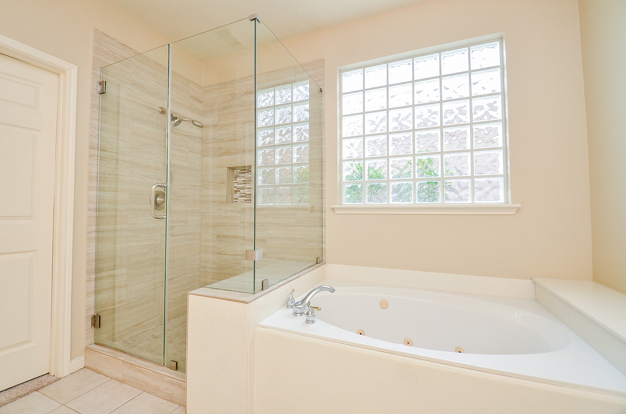 1222 Ragsdale Lane Katy, TX 77494 - Photo 19 of 31 Shower has toiletry niche with accented colors and updated fixtures. Relax in your jetted tub after a long, productive day. Enjoy privacy and natural lighting with the block glass window.