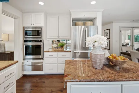 a kitchen with a stove and refrigerator
