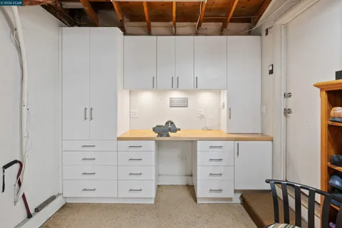 a view of a patio with table and chairs under an umbrella