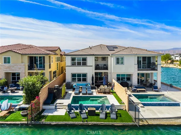 a view of a house with swimming pool and sitting area