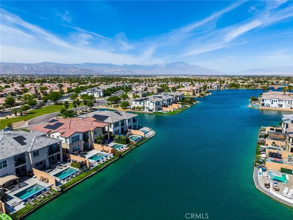 an aerial view of residential houses with outdoor space and river