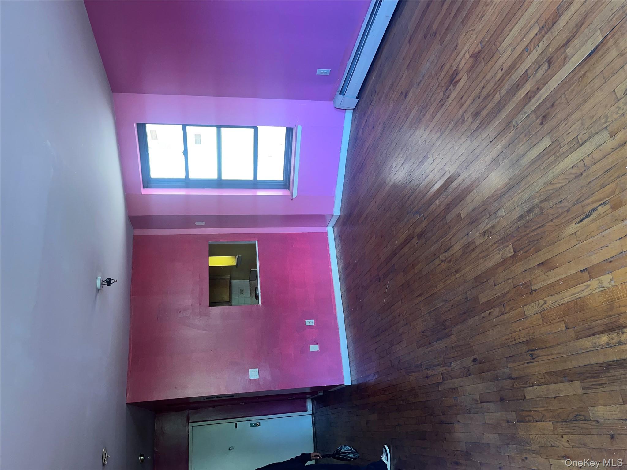 18 East 132nd Street, Unit 3A Manhattan, NY 10037 - Photo 2 of 11 a view of empty room with wooden floor and fan