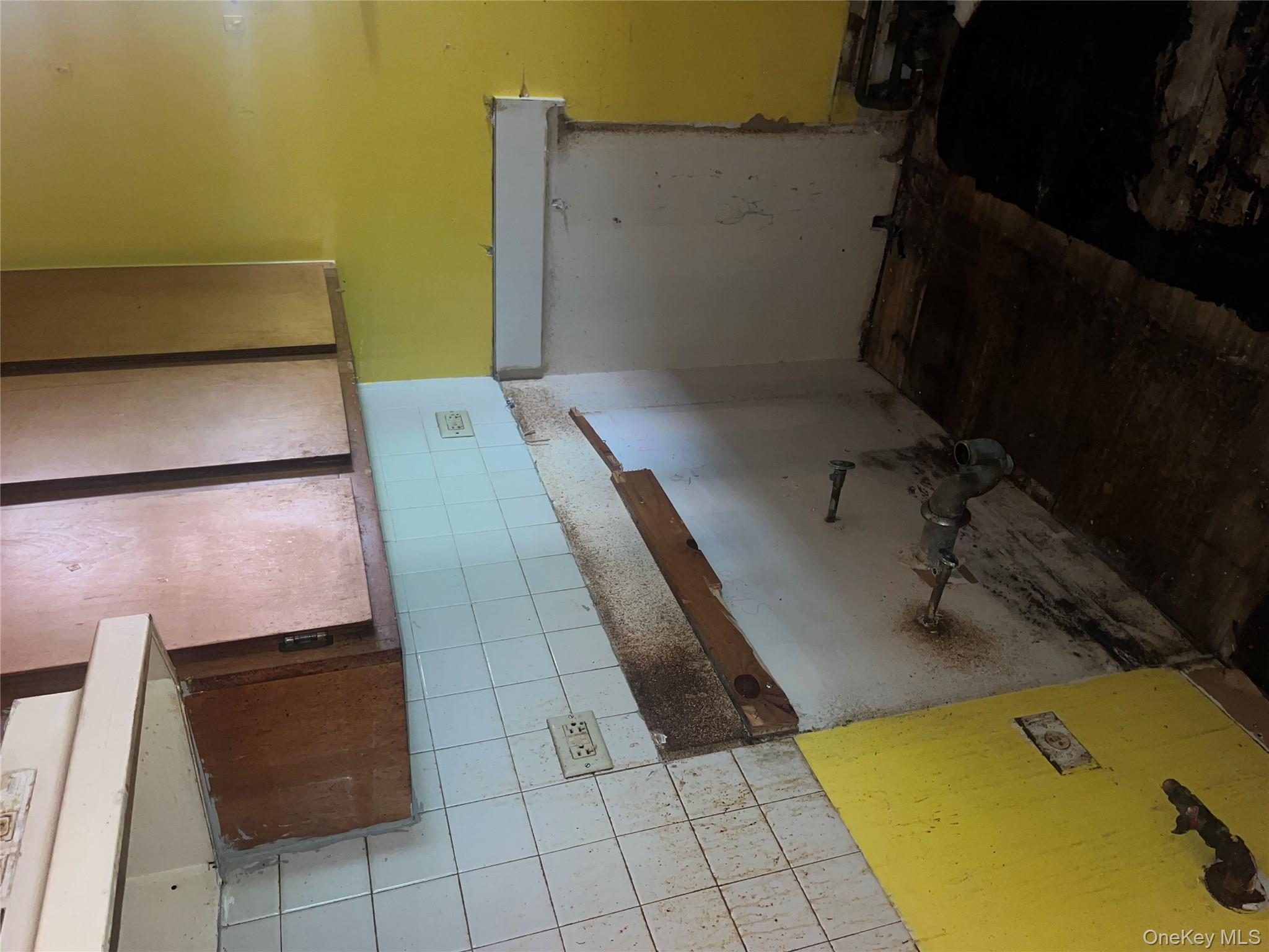 18 East 132nd Street, Unit 3A Manhattan, NY 10037 - Photo 7 of 11 a room with water heater and wooden cabinets