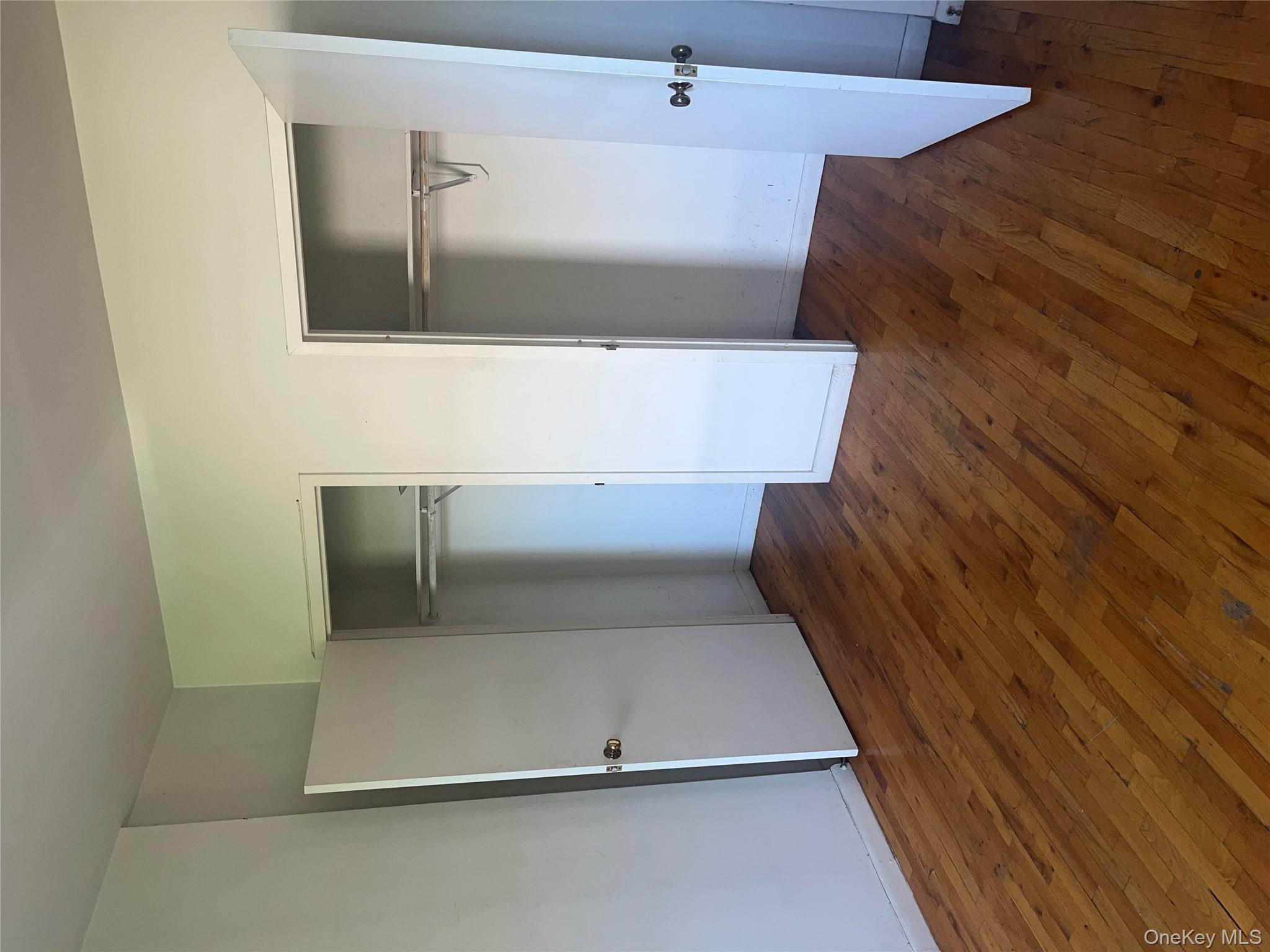 18 East 132nd Street, Unit 3A Manhattan, NY 10037 - Photo 10 of 11 a view of an empty room with wooden floor and a window