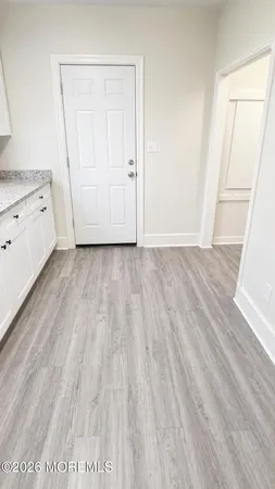 a view of a room with wooden floor and cabinet