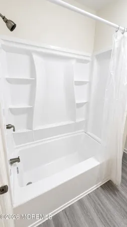 a bathroom with a bathtub and a shower