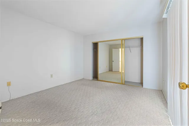 an empty room with closet area