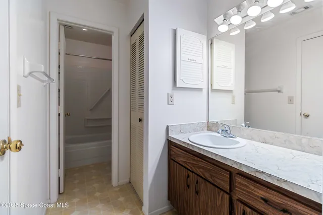 a bathroom with a sink a vanity and a mirror