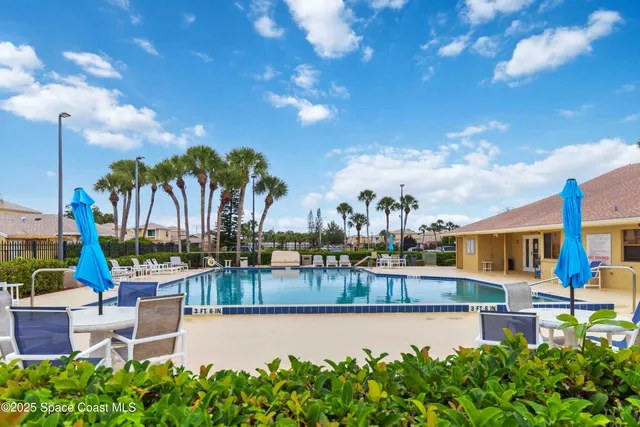 a view of a swimming pool with outdoor seating