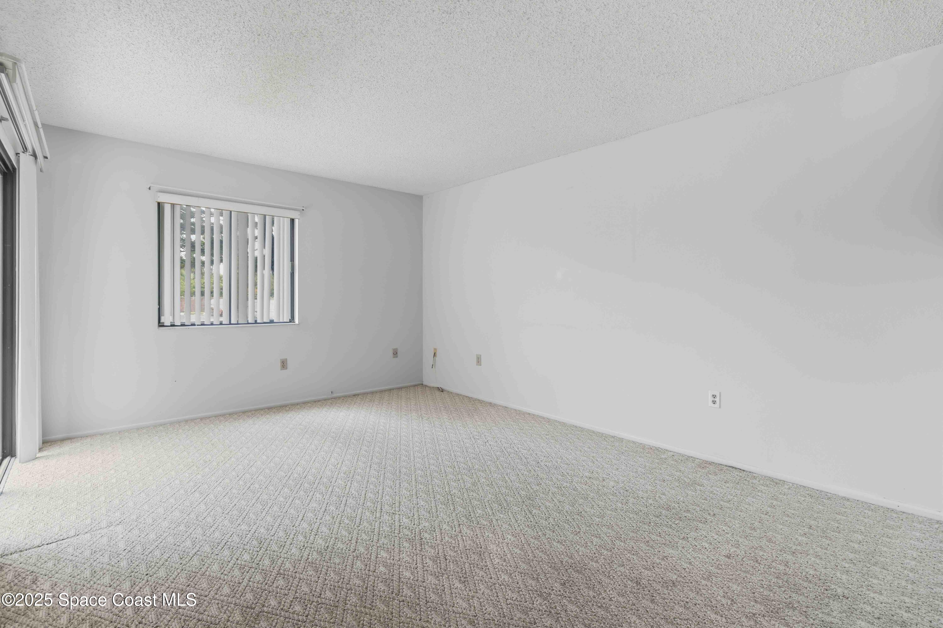 1020 Abada Court Northeast, Unit 103 Palm Bay, FL 32905 - Photo 5 of 26 an empty room with windows