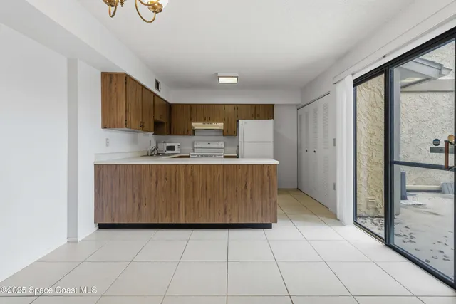 a kitchen with kitchen island a counter top a sink a stove and a refrigerator
