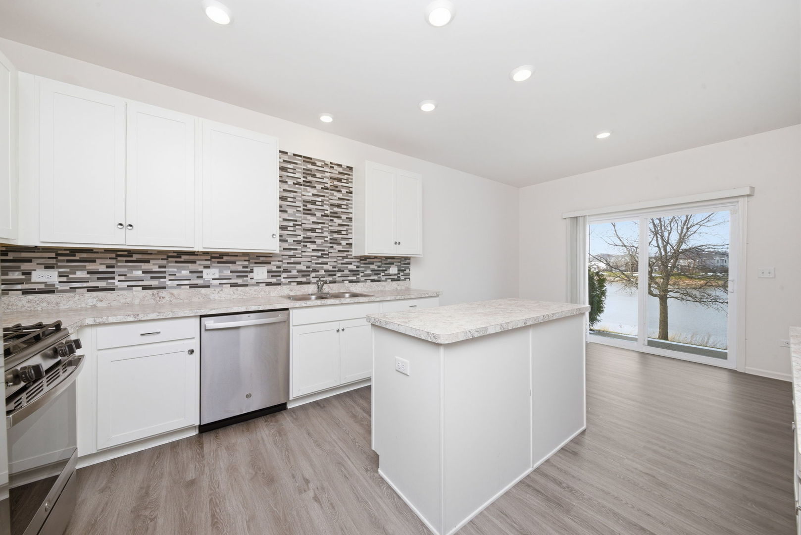 2017 Pembridge Lane Joliet, IL 60431 - Photo 4 of 19 a kitchen with granite countertop white cabinets and white appliances