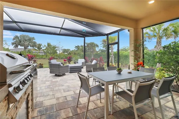 a view of a patio with a table chairs and a backyard