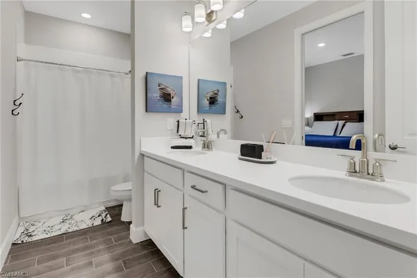 a bathroom with double vanity sinks and a mirror