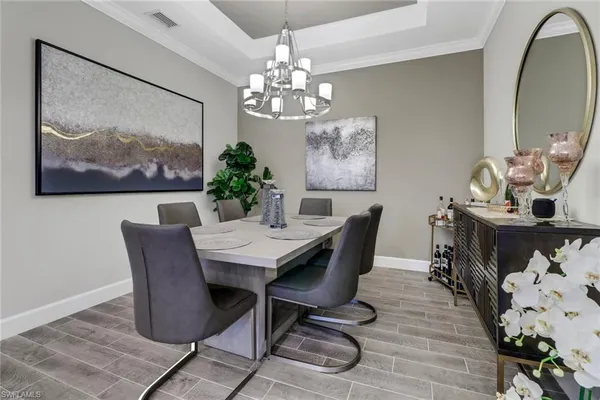 a view of a dining room with furniture wooden floor and a chandelier