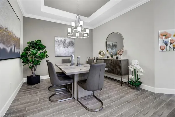 a view of a dining room with furniture wooden floor and chandelier
