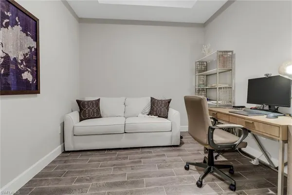 a view of a livingroom with workspace and a couch