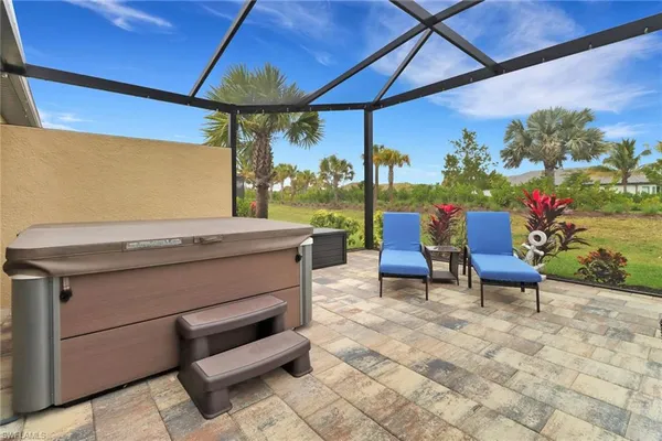 a view of a patio with a table and chairs under an umbrella