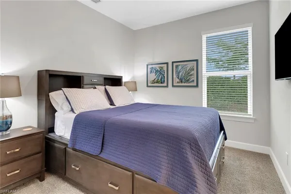 a bedroom with a large bed and a window