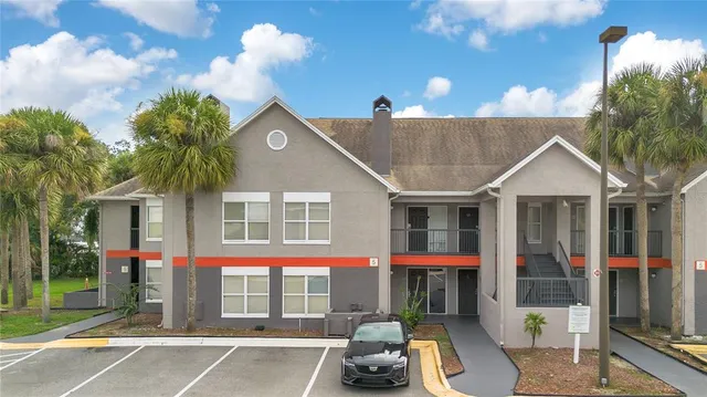 a view of a white house with large windows and a table