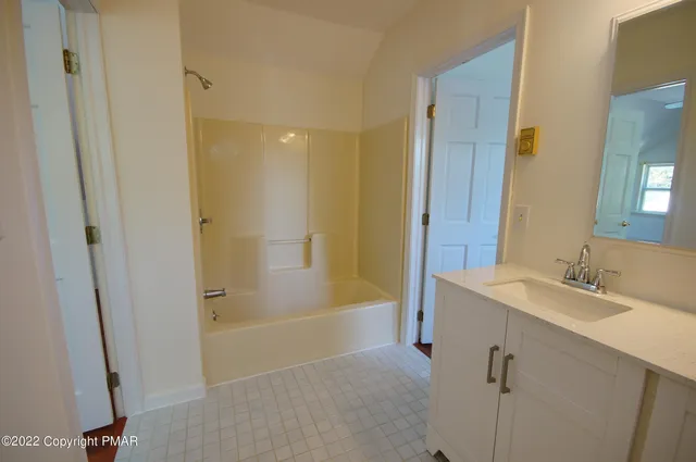 a bathroom with a sink a mirror and a bathtub