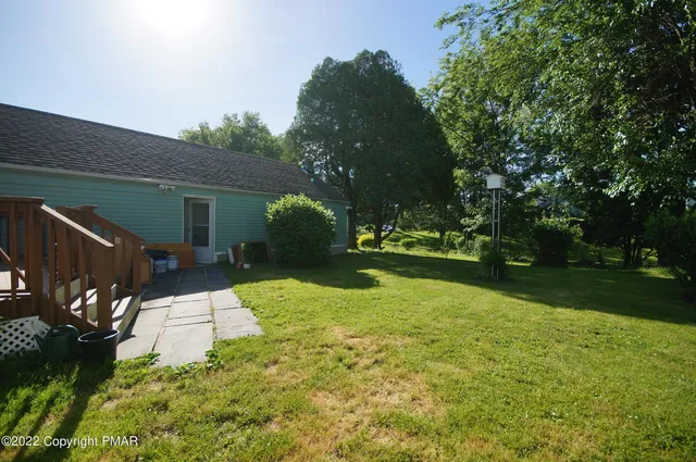 a view of backyard of house with green space