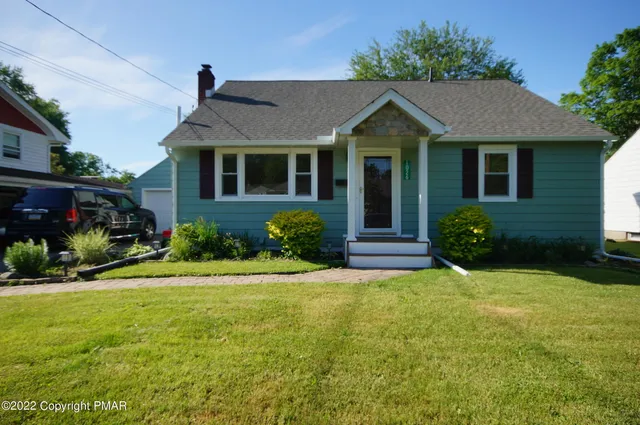 front view of a house with a yard