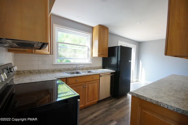 a kitchen with a sink stove and refrigerator