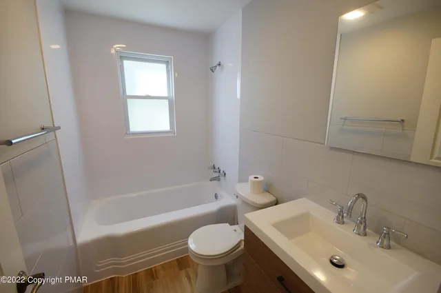 a bathroom with a sink toilet and bathtub