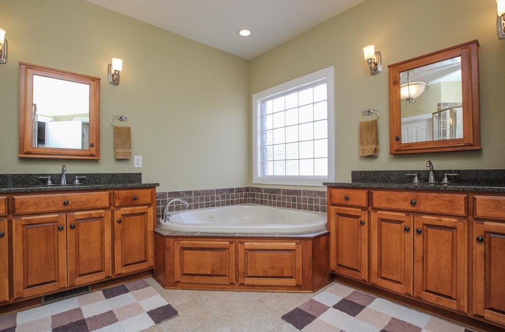 2619 Cooks Road Mount Juliet, TN 37122 - Photo 16 of 30 a spacious bathroom with granite countertop double vanity sink a mirror a bathtub and window