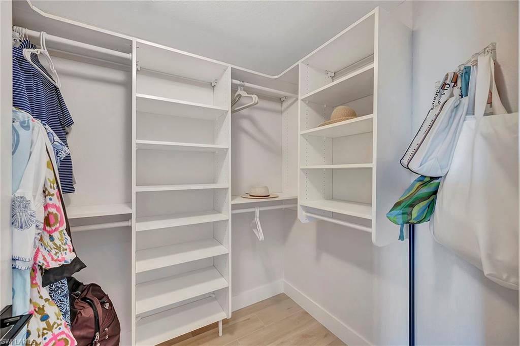 7671 Pebble Creek Circle, Unit 303 Naples, FL 34108 - Photo 20 of 28 Primary Walk-in Closet