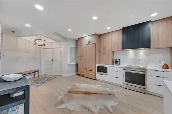 a kitchen with granite countertop a sink stainless steel appliances and cabinets