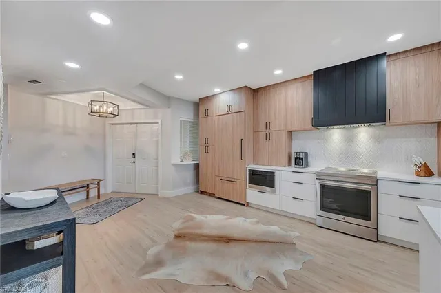a kitchen with granite countertop a sink stainless steel appliances and cabinets