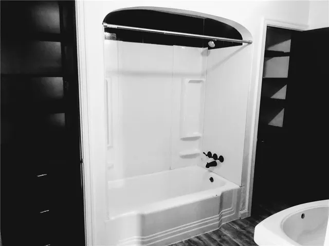 a bathroom with a bathtub and a shower