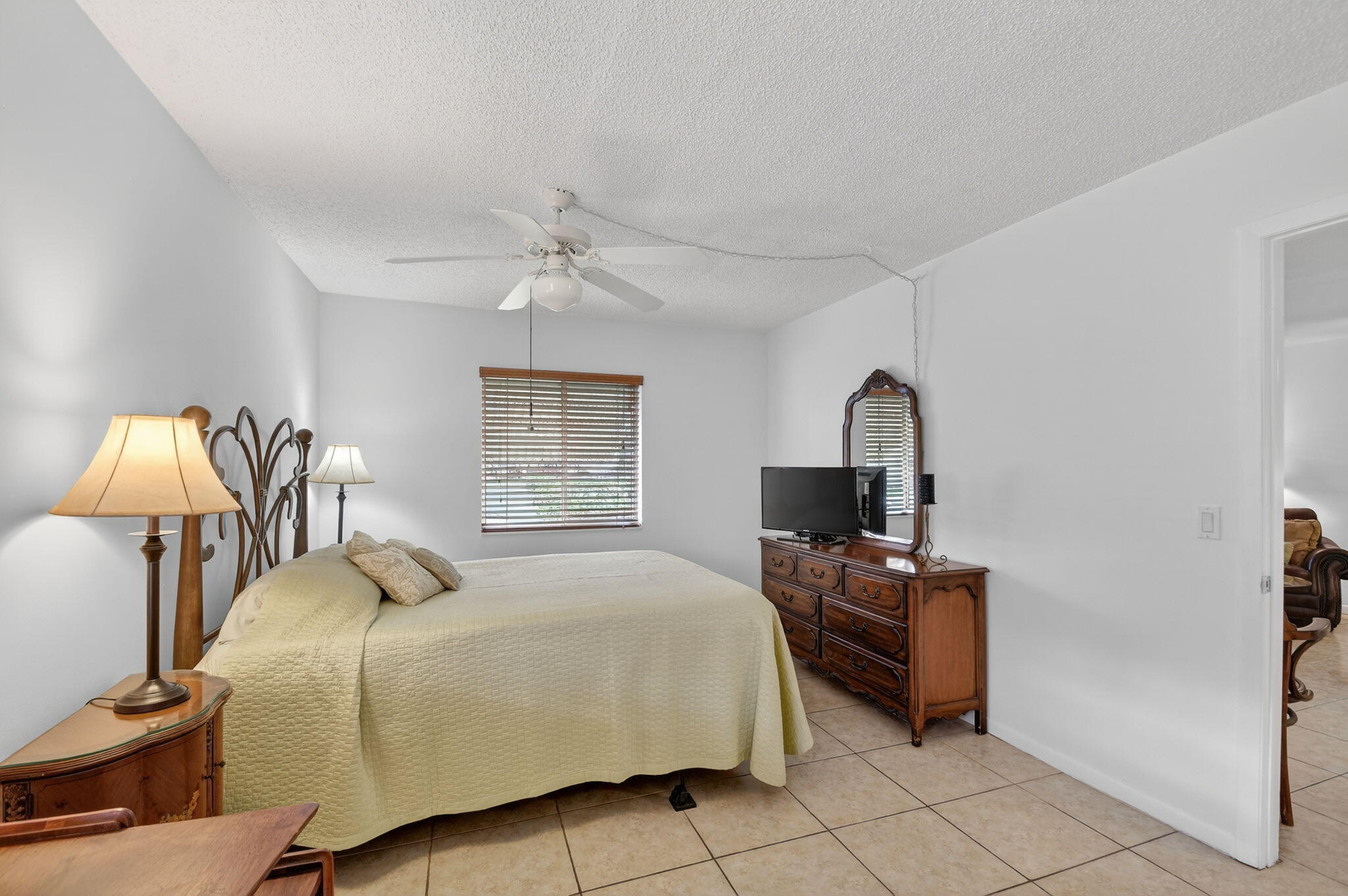 342 Pine Ridge Circle, Unit D1 Greenacres, FL 33463 - Photo 16 of 24 a bedroom with a bed a desk and chair
