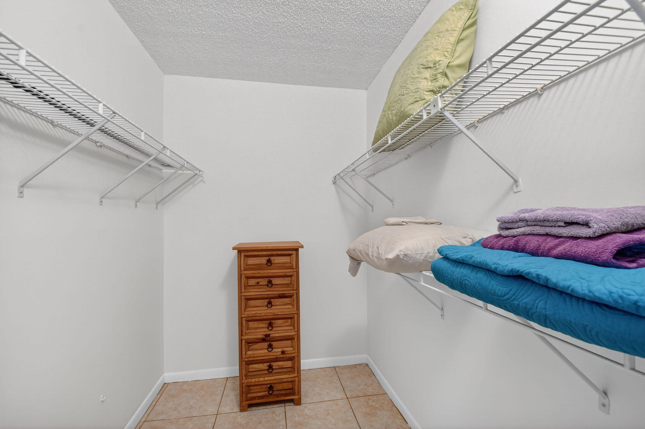 342 Pine Ridge Circle, Unit D1 Greenacres, FL 33463 - Photo 19 of 24 a view of walk in closet with clothes