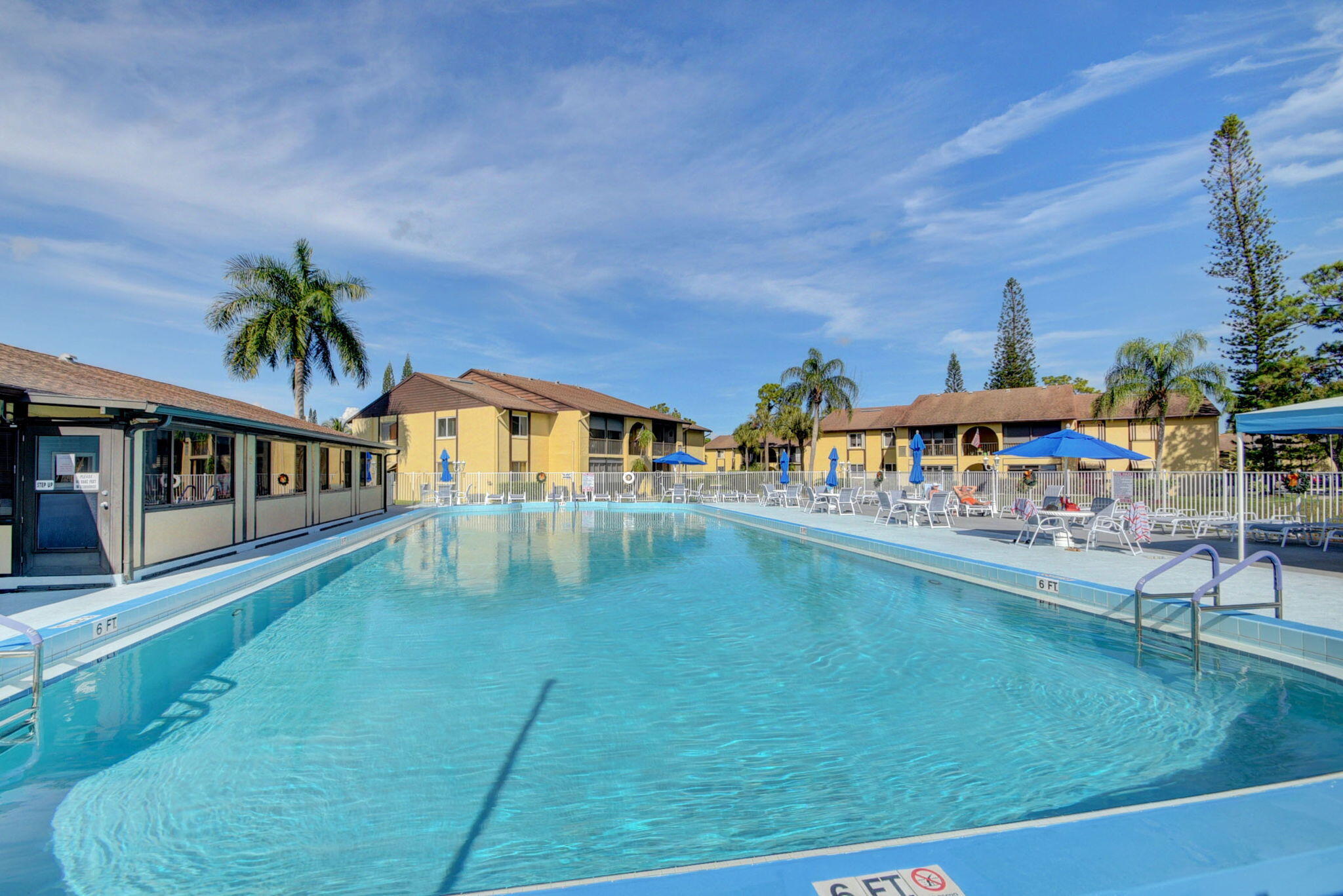 342 Pine Ridge Circle, Unit D1 Greenacres, FL 33463 - Photo 22 of 24 a swimming pool view with a garden space