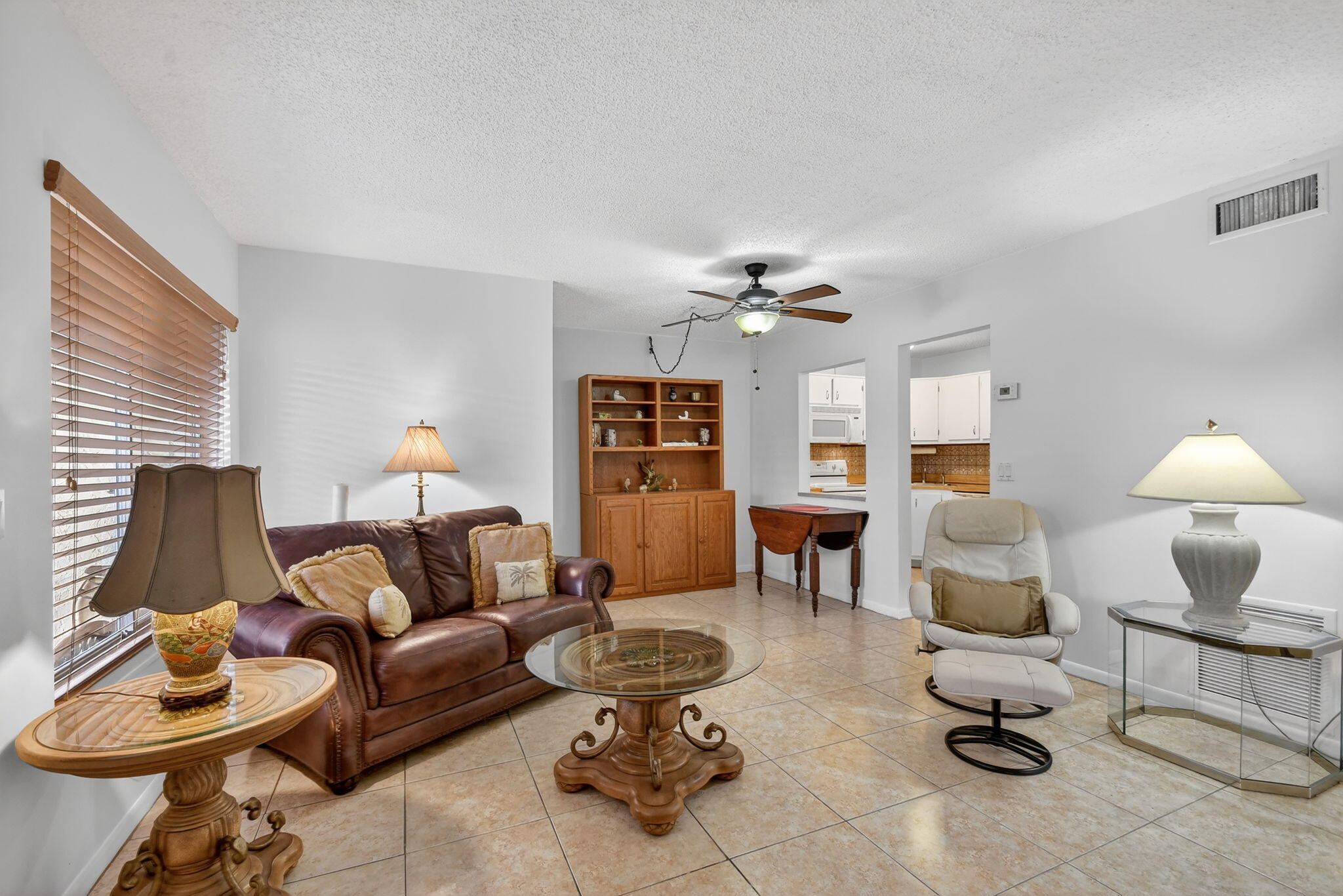 342 Pine Ridge Circle, Unit D1 Greenacres, FL 33463 - Photo 6 of 24 a living room with furniture a dining table and window with wooden floor