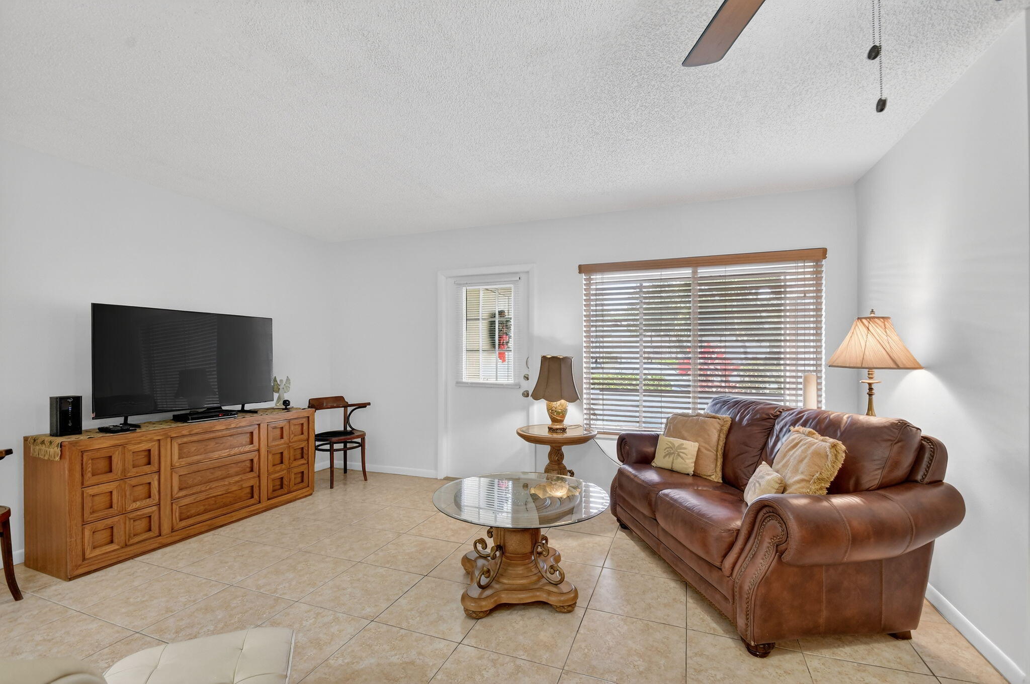 342 Pine Ridge Circle, Unit D1 Greenacres, FL 33463 - Photo 8 of 24 a living room with furniture and a flat screen tv